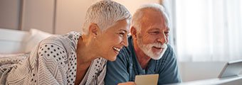 older couple looking at a phone screen together and smiling