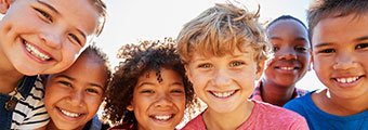 a group of diverse kids all smiling