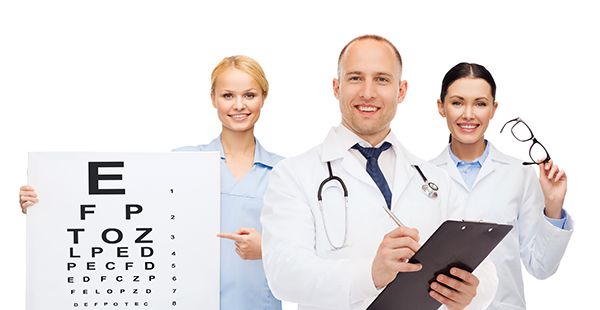 photo of three eye doctors holding an eye exam chart