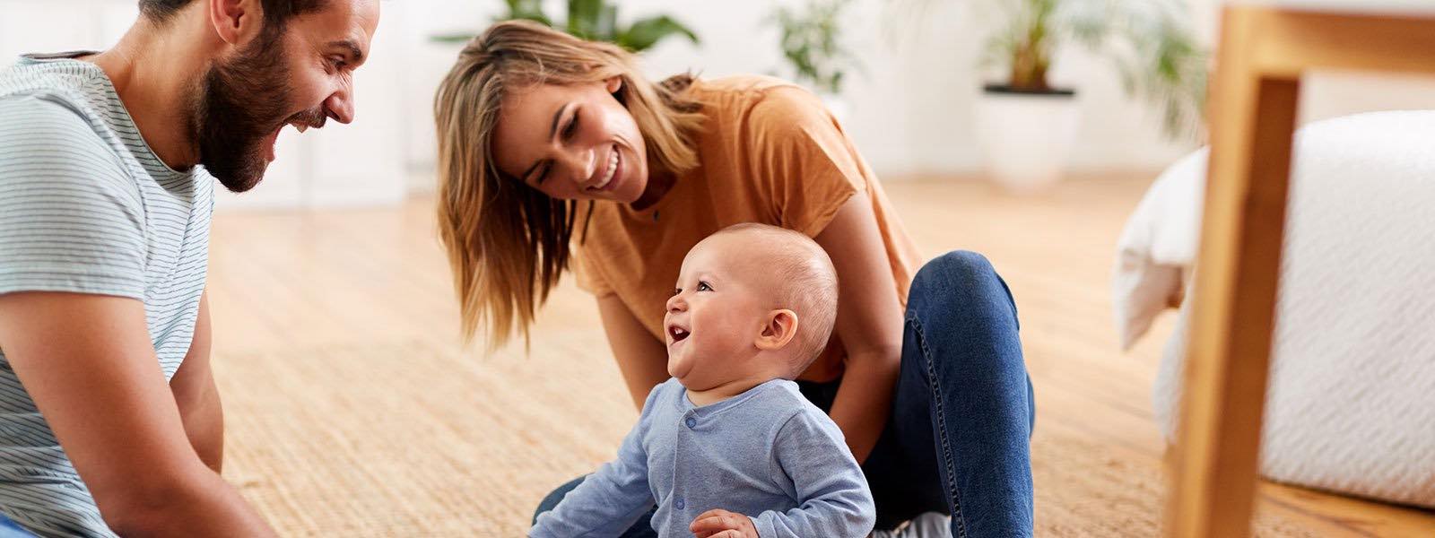 mother laughing with a baby