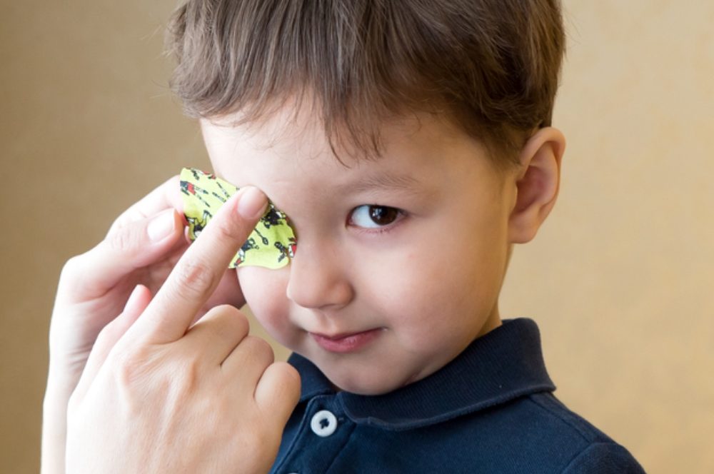 child in eye patch